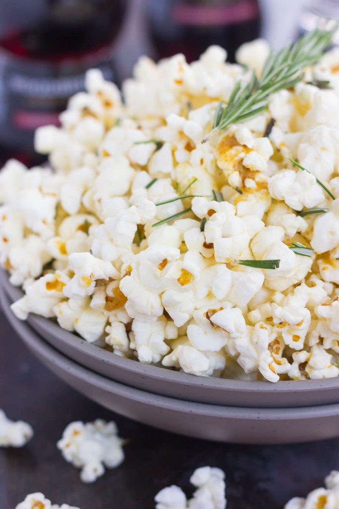 This Rosemary Garlic Popcorn is drizzled with a buttery mix filled with fresh rosemary and a hint of garlic. Simple, easy, and perfect for on-the-go entertaining, this crunchy snack is sure to be the hit of any party!