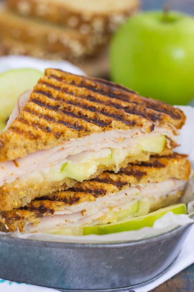 This Turkey, Apple and Brie Panini is the perfect fall-inspired sandwich. It's packed with fresh turkey, granny smith apples, creamy brie cheese and then toasted until golden. Simple, fast, and bursting with flavor, this sweet and savory combo makes a delicious lunch or dinner! #panini #turkeypanini #sandwich #sandwichrecipe #paninirecipe #lunch #dinner