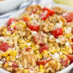 Grilled Garlic Herb Corn and Tomatoes with Walnuts is an easy side dish that's ready in minutes. Fresh corn off the cob, cherry tomatoes, feta cheese, and walnuts give this dish a flavorful punch that's perfect to pair alongside your favorite meal!