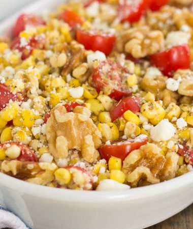 Grilled Garlic Herb Corn and Tomatoes with Walnuts is an easy side dish that's ready in minutes. Fresh corn off the cob, cherry tomatoes, feta cheese, and walnuts give this dish a flavorful punch that's perfect to pair alongside your favorite meal!