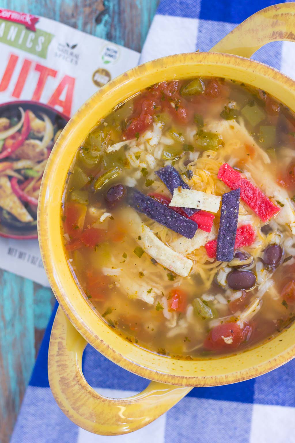 overhead view of bowl of chicken fajita soup and a packet of fajita seasoning mix