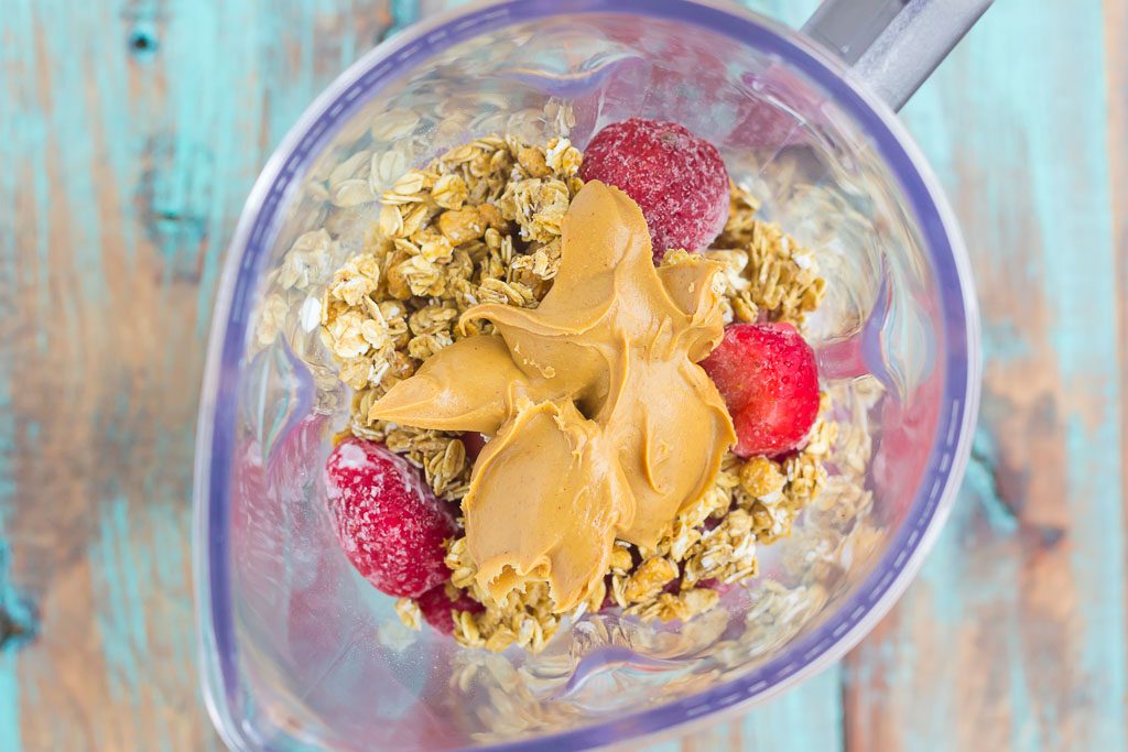 This Peanut Butter and Jelly Granola Smoothie is thick, creamy, and packed with a classic peanut butter and jelly taste, in drink form. Filled with frozen strawberries, vanilla Greek yogurt, creamy peanut butter, and crunchy granola, this smoothie is ready just minutes and is perfect to serve for just about any meal!