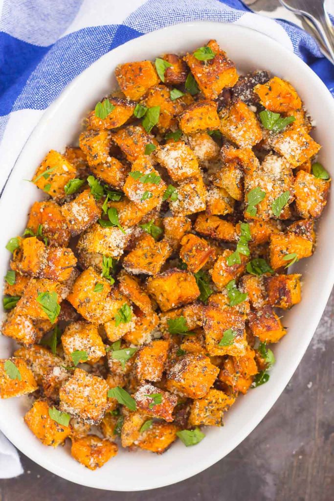 top down shot of baked sweet potato cubes in a white oval dish