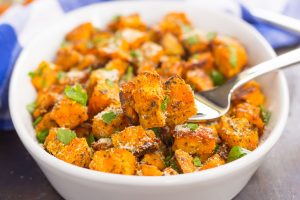 savory roasted sweet potatoes in a bowl with a fork
