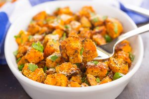 savory roasted sweet potatoes in a bowl with a fork