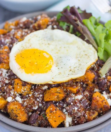 This Roasted Parmesan Sweet Potato Quinoa Bowl is a deliciously simple dish that is perfect for a light lunch or dinner. Filled with roasted sweet potatoes, hearty quinoa, black beans, feta cheese, and a fried egg, this bowl is jam-packed with flavor and so easy to make!