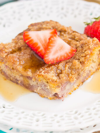 This Strawberry Cinnamon Pancake Casserole is a dish that the whole family will enjoy. Fluffy pancakes are studded with juicy strawberries, a cinnamon spread, and then back until golden. Topped sweet streusel and maple syrup, this dish is a wholesome, feel-good meal!