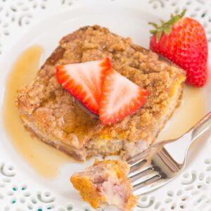 This Strawberry Cinnamon Pancake Casserole is a dish that the whole family will enjoy. Fluffy pancakes are studded with juicy strawberries, a cinnamon spread, and then back until golden. Topped sweet streusel and maple syrup, this dish is a wholesome, feel-good meal!