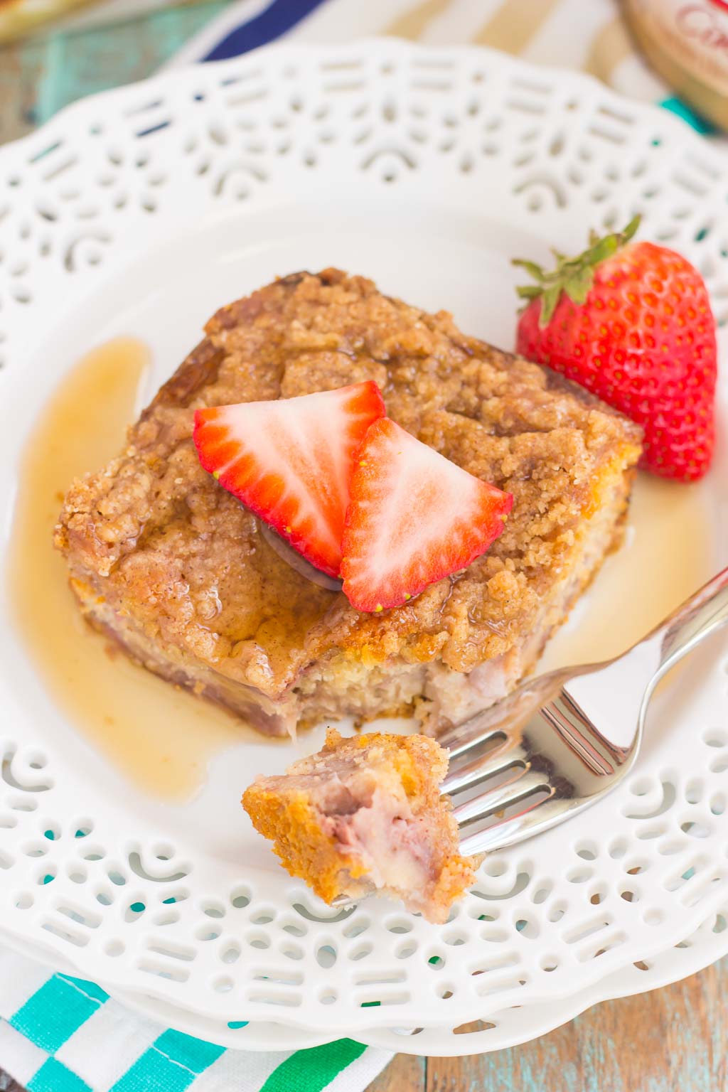This Strawberry Cinnamon Pancake Casserole is a dish that the whole family will enjoy. Fluffy pancakes are studded with juicy strawberries, a cinnamon spread, and then back until golden. Topped sweet streusel and maple syrup, this dish is a wholesome, feel-good meal!