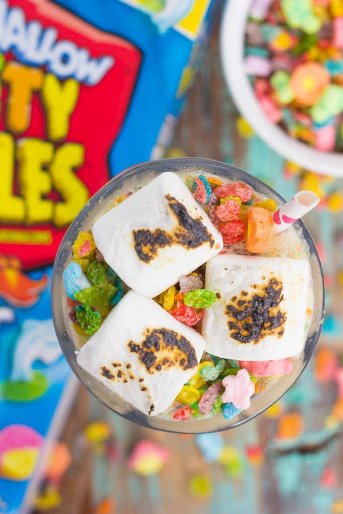 This Toasted Marshmallow Fruity Pebble Milkshake is loaded with creamy vanilla ice cream, a swirl of cereal, and topped with toasted marshmallows. With just four ingredients and hardly any prep time, you can indulge in this delicious frozen treat to beat the summer heat!