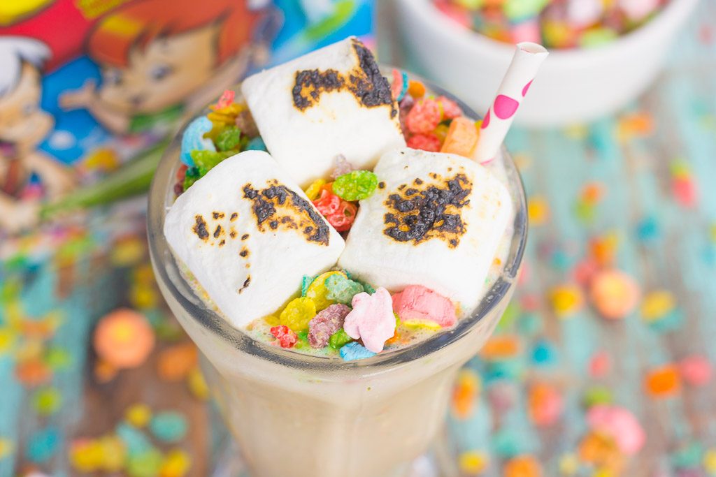This Toasted Marshmallow Fruity Pebble Milkshake is loaded with creamy vanilla ice cream, a swirl of cereal, and topped with toasted marshmallows. With just four ingredients and hardly any prep time, you can indulge in this delicious frozen treat to beat the summer heat!