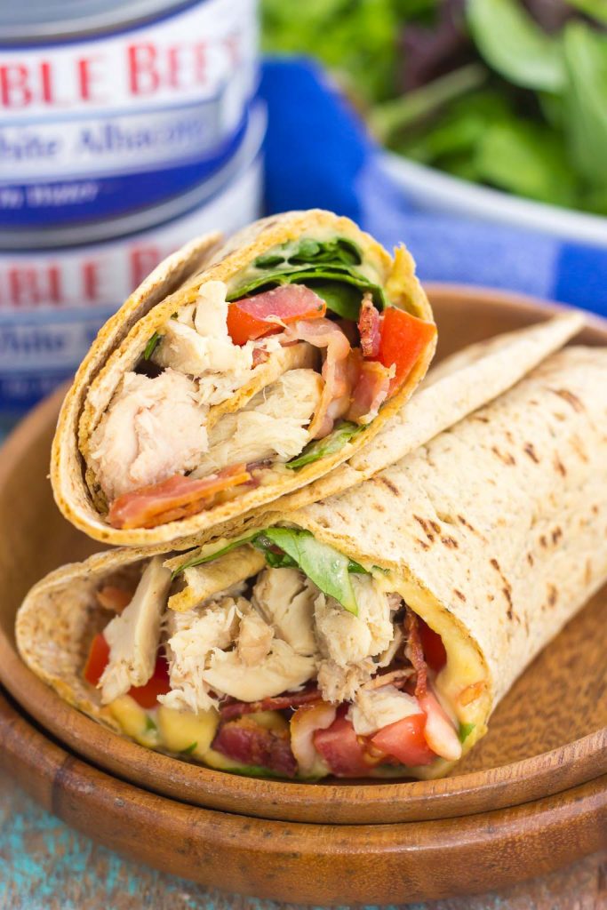 This Tuna Spinach Wrap is filled with hearty tuna, fresh spinach, crisp bacon, and tomatoes. Simple, fresh and easy to make, this dish comes together in minutes and serves as a perfect lunch or dinner for back-to-school times! #tuna #tunawrap #tunasandwich #spinachwrap #lunch #easylunch #dinner