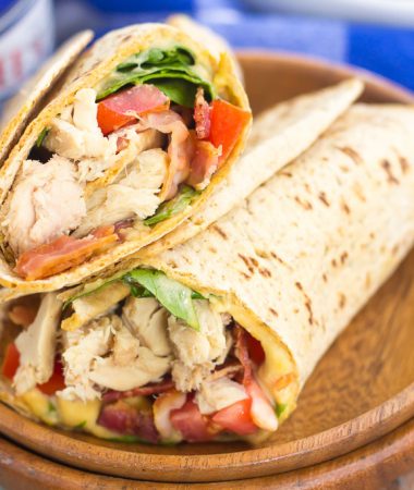 This Tuna Spinach Wrap is filled with hearty tuna, fresh spinach, crisp bacon, and tomatoes. Simple, fresh and easy to make, this dish comes together in minutes and serves as a perfect lunch or dinner for back-to-school times!