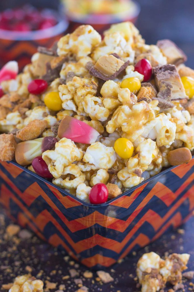 This Peanut Butter Candy Popcorn is the perfect sweet and salty snack to satisfy your sweet tooth! Fresh popcorn is coated with a creamy peanut butter mixture and then tossed with a variety of candies. It makes the best snack to munch on during Halloween, and is also a great way to use up that leftover candy!