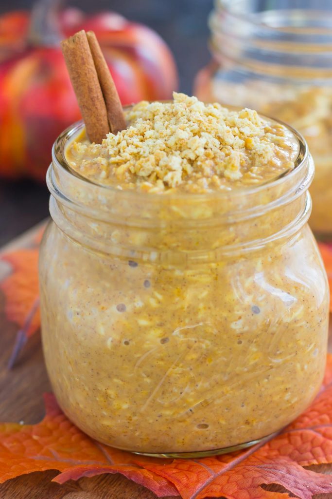 glass jar of pumpkin spice overnight oats garnished with a cinnamon stick