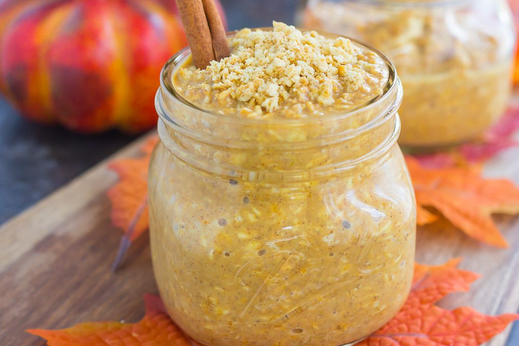 side view of jar of pumpkin pie overnight oats garnished with a cinnamon stick
