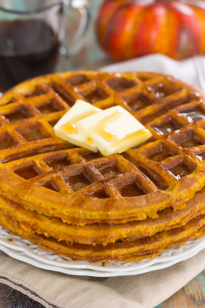 These Pumpkin Spice Waffles are crispy on the outside, tender on the inside, and filled with cozy fall flavors. You can satisfy your craving for pumpkin with this easy breakfast that's sure to be a favorite all year long! #waffles #wafflerecipe #pumpkinrecipe #pumpkinwaffles #pumpkinbreakfast #breakfast #breakfastrecipes