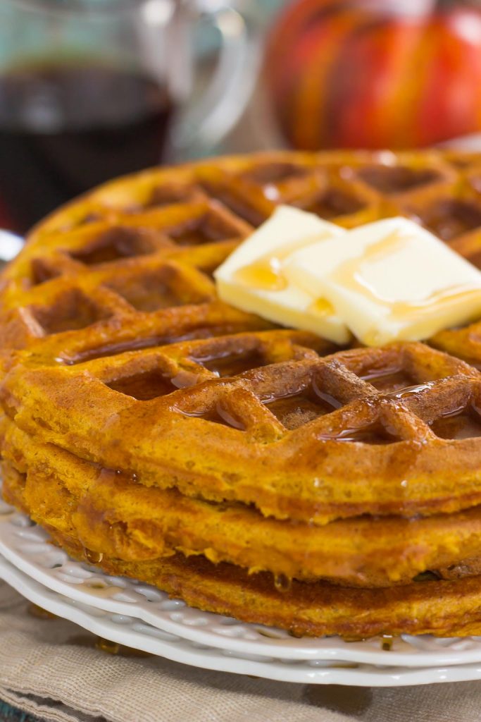 These Pumpkin Spice Waffles are crispy on the outside, tender on the inside, and filled with cozy fall flavors. You can satisfy your craving for pumpkin with this easy breakfast that's sure to be a favorite all year long! #waffles #wafflerecipe #pumpkinrecipe #pumpkinwaffles #pumpkinbreakfast #breakfast #breakfastrecipes