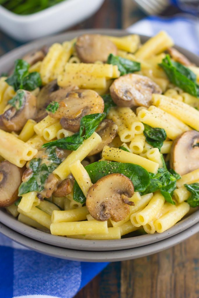 spinach mushroom pasta in grey bowl