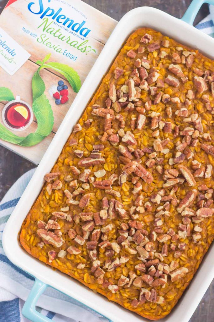 Overhead view of a pan of pumpkin baked oatmeal topped with chopped pecans. 