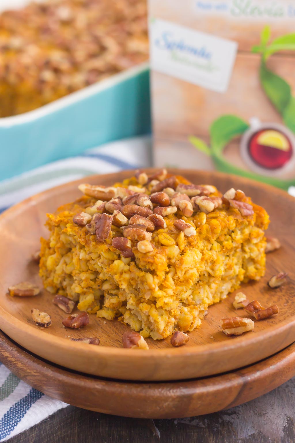 A slice of pumpkin pie baked oatmeal on a stack of wooden plates.