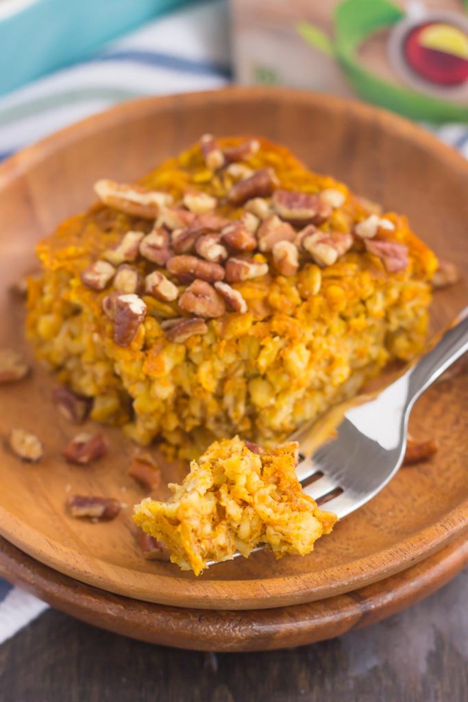 A slice of pumpkin pie baked oatmeal on a stack of wooden plates. 