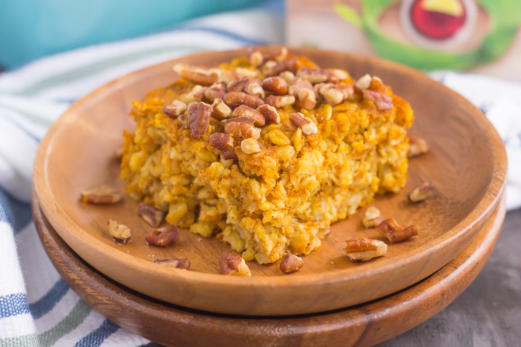 A slice of pumpkin pie baked oatmeal on a stack of wooden plates. 