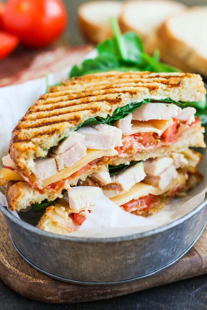 This Bacon Ranch Chicken Panini is loaded with tender chunks of chicken, crisp bacon, fresh spinach, Havarti cheese, and a garlic ranch dressing!