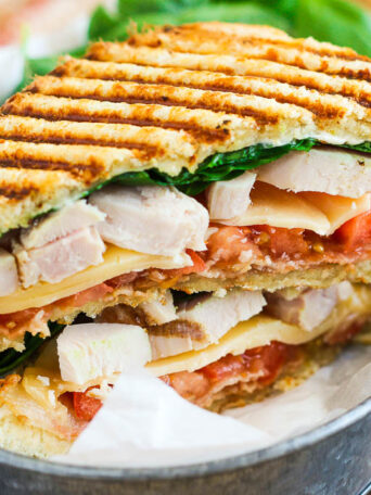 This Chicken Bacon Ranch Panini is fast, fresh, and ready in no time. Loaded with tender chunks of chicken, crisp bacon, fresh spinach, Havarti cheese, and a garlic ranch dressing, this sandwich is packed with flavor and makes the perfect, easy meal!