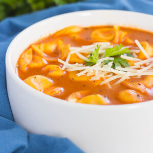 This Creamy Tomato Tortellini Soup is the perfect kind of comfort food for cold, winter days. Loaded with cheese tortellini, herbs, and made in one pot, you can have this rich and flavorful soup ready in less than thirty minutes!