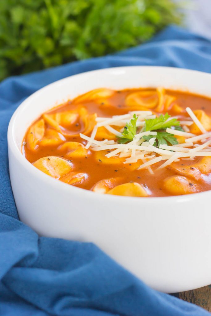 white bowl filled with tomato tortellini soup