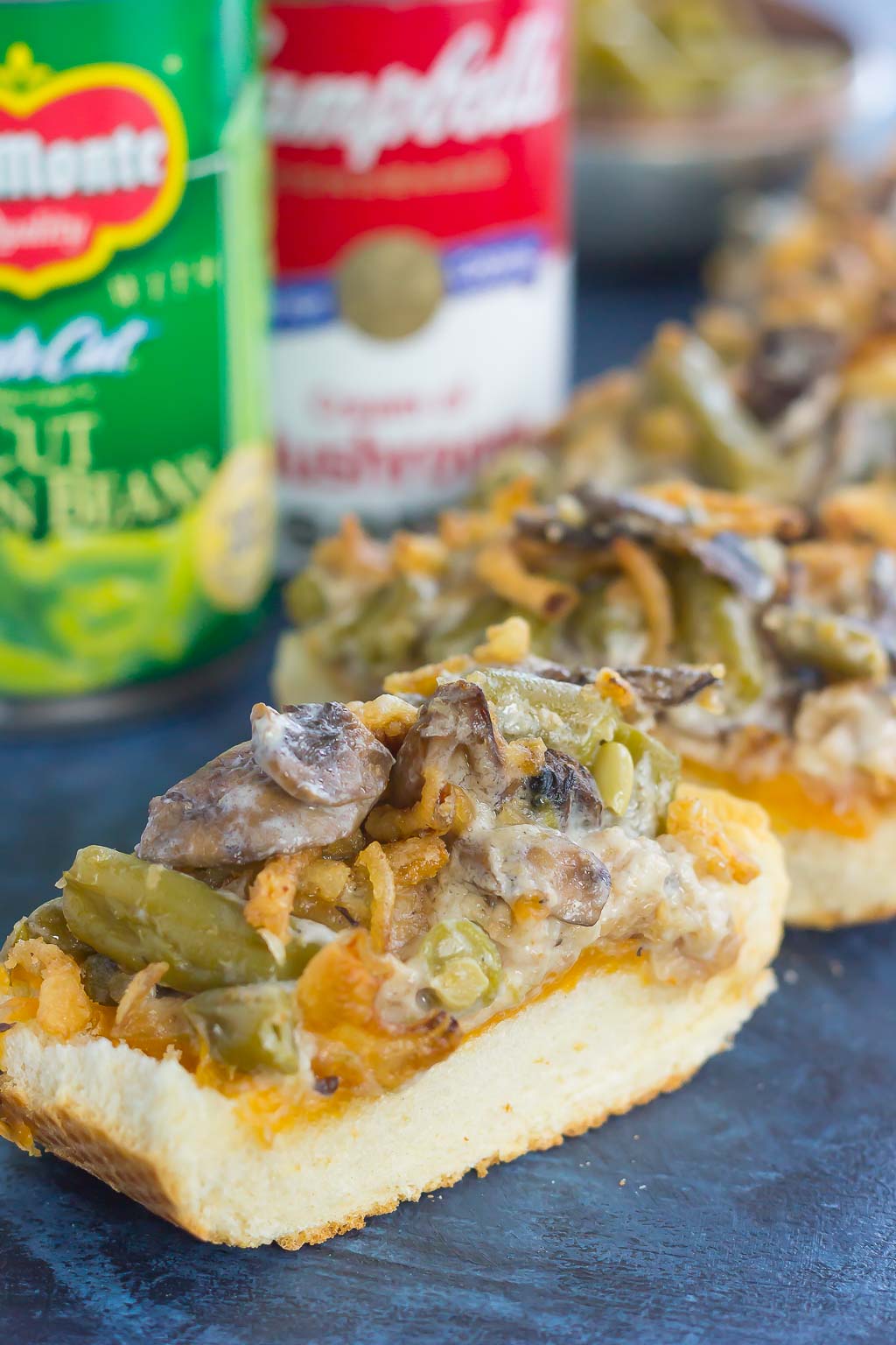 This Green Bean Casserole Cheesy Bread puts a creative spin on the classic holiday side dish. The zesty casserole is made in just one pan, piled on top of toasted cheesy bread, and then baked until warm and bubbly. This simple dish is fast, fresh, flavorful and will become the hit of the dinner table!