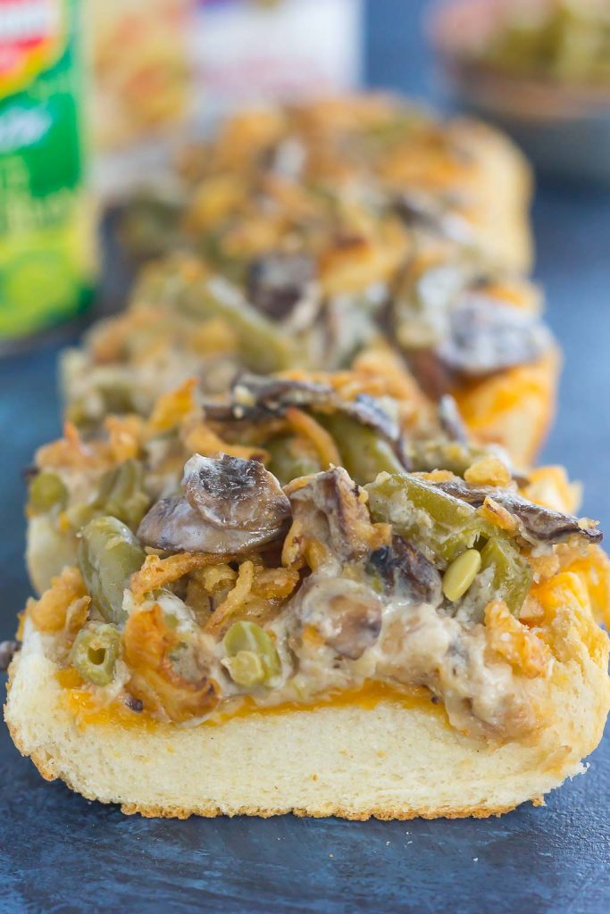 This Green Bean Casserole Cheesy Bread puts a creative spin on the classic holiday side dish. The zesty casserole is made in just one pan, piled on top of toasted cheesy bread, and then baked until warm and bubbly. This simple dish is fast, fresh, flavorful and will become the hit of the dinner table! #bread #cheesybread #greenbeancasserolerecipes #greenbeanrecipe #thanksgiving #thanksgivingrecipes