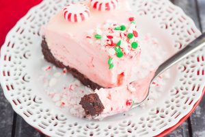 a piece of candy cane cheesecake on a plate with a fork