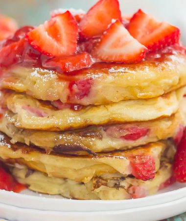 These Strawberry Greek Yogurt Pancakes are thick, fluffy, and loaded with juicy strawberries in every bite. Made with Greek yogurt for a healthier twist and topped with an easy strawberry sauce, you're going to fall in love with the sweet taste of these pancakes!