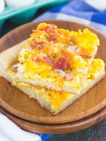 If you're looking for a new way to eat eggs and bacon, then this is it! This Bacon and Egg Breakfast pizza is filled with scrambled eggs, two kinds of cheese, and bacon, all sprinkled on top of a crisp crust. With just a few ingredients and minimal prep time, this breakfast pizza will be a meal time winner for breakfast, lunch, or even dinner!