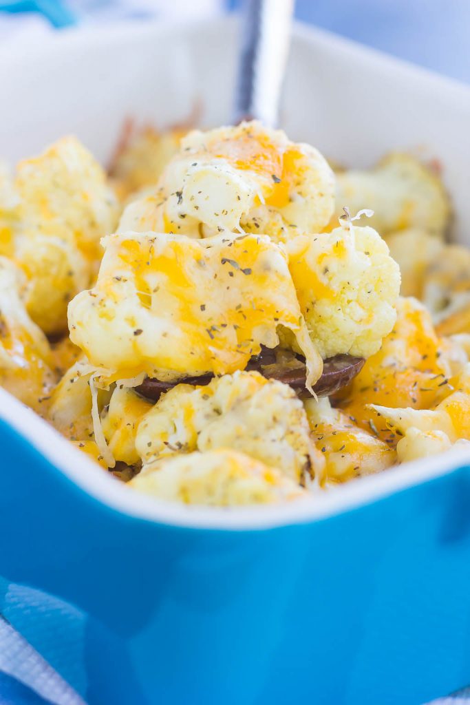 This Baked Cheesy Cauliflower is delicious way to jazz up your favorite veggie. Cauliflower florets are drizzled with olive oil, a blend of seasonings, and topped with two kinds of cheese. Baked until tender and oozing with flavor, this easy vegetable will quickly become a new mealtime favorite!