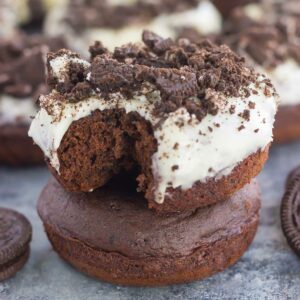 These Baked Oreo Donuts feature a rich, chocolate donut, studded with Oreo cookies and baked to perfection. Topped with a sweet cream cheese glaze and sprinkled with crumbled cookies, these donuts make the best breakfast or dessert!