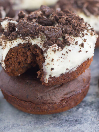 These Baked Oreo Donuts feature a rich, chocolate donut, studded with Oreo cookies and baked to perfection. Topped with a sweet cream cheese glaze and sprinkled with crumbled cookies, these donuts make the best breakfast or dessert!