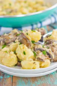 zoomed in shot of fork taking a scoop of mushroom gnocchi