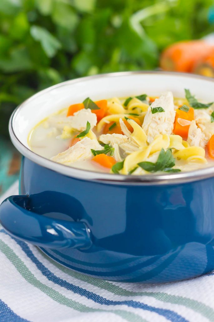 Crockpot creamy chicken noodle soup in a blue bowl. 