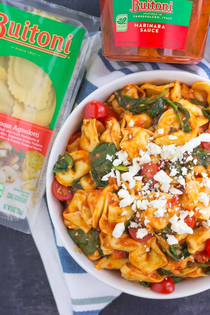 This Spinach and Feta Tortellini is fresh, flavorful, and ready in less than 30 minutes. Cheese tortellini is tossed in a zesty marinara sauce and sprinkled with fresh spinach and crumbled feta cheese. Easy to make and perfect for busy weeknights, this warm and comforting pasta will fill you up and keep you coming back for more!