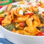 This Spinach and Feta Tortellini is fresh, flavorful, and ready in less than 30 minutes. Cheese tortellini is tossed in a zesty marinara sauce and sprinkled with fresh spinach and crumbled feta cheese. Easy to make and perfect for busy weeknights, this warm and comforting pasta will fill you up and keep you coming back for more!