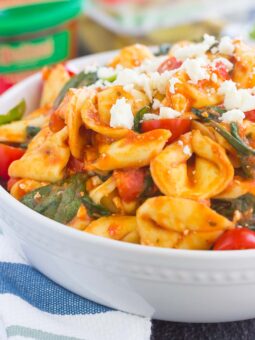 This Spinach and Feta Tortellini is fresh, flavorful, and ready in less than 30 minutes. Cheese tortellini is tossed in a zesty marinara sauce and sprinkled with fresh spinach and crumbled feta cheese. Easy to make and perfect for busy weeknights, this warm and comforting pasta will fill you up and keep you coming back for more!