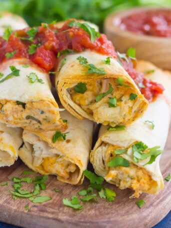 These Baked Chicken Ranch Taquitos are loaded with shredded chicken, cheddar cheese, cilantro, and a savory ranch cream cheese mixture. Fast, easy, and ready in less than 30 minutes, this simple dish is packed with flavor and perfect for the whole family!