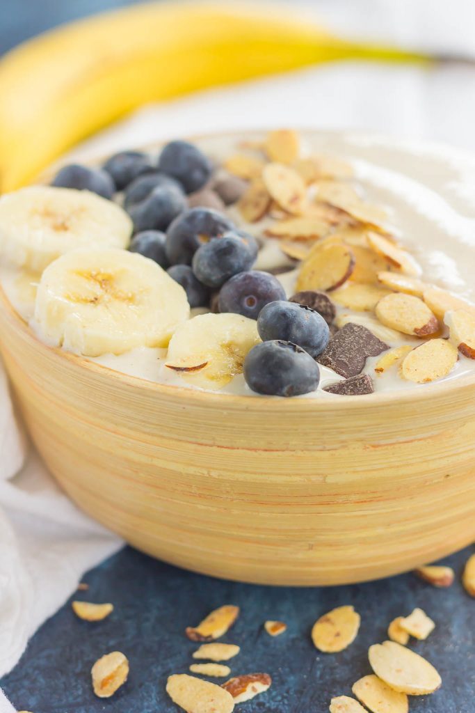 side view of a banana smoothie bowl with toppings