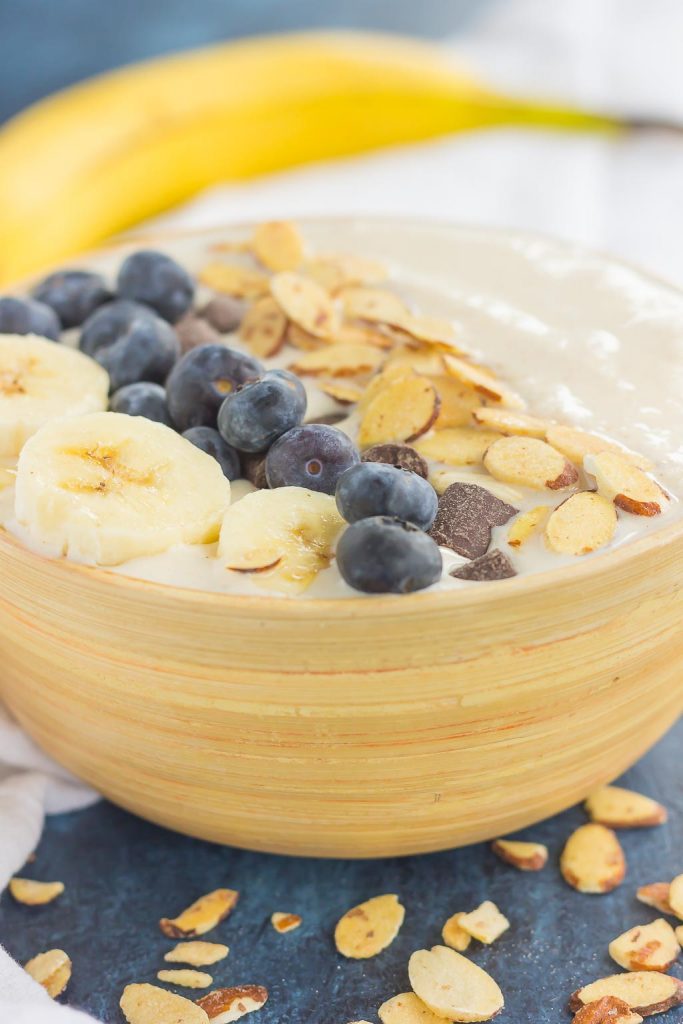a banana breakfast smoothie bowl with toppings 
