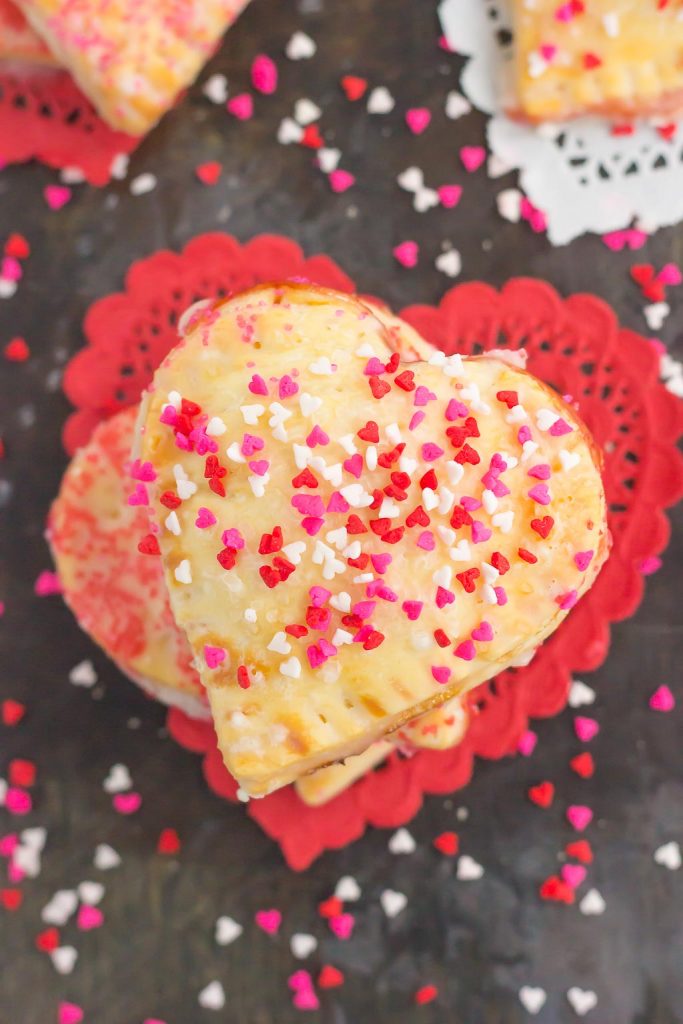 These Mini Strawberry Heart Pies are the perfect dessert for spoiling your sweetie on Valentine's Day or for entertaining those party guests. A pre-made pie crust is cut into the shape of hearts and then filled with sweet strawberry jam. It's an impressive treat that looks time-consuming but is so easy to make!