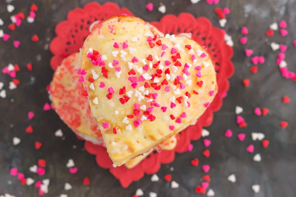 These Mini Strawberry Heart Pies are the perfect dessert for spoiling your sweetie on Valentine's Day or for entertaining those party guests. A pre-made pie crust is cut into the shape of hearts and then filled with sweet strawberry jam. It's an impressive treat that looks time-consuming but is so easy to make!