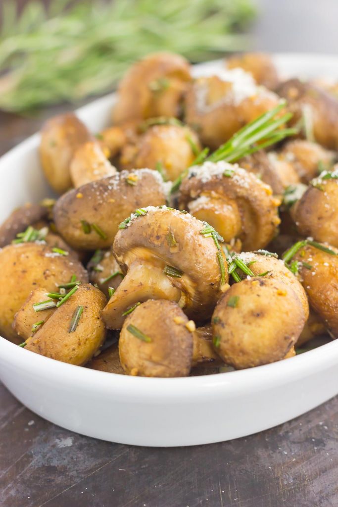 These Roasted Mushrooms with Garlic and Rosemary are loaded with a savory mixture of herbs and then baked until golden. Fast, fresh and easy to make, these mushrooms take less than 30 minutes from start to finish! #mushrooms #roastedmushrooms #mushroomrecipe #garlicmushrooms #rosemarymushrooms #sidedish #easysidedish